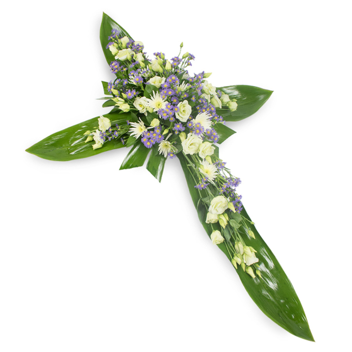 Arranged with the measured hand of a local florist, this sympathy cross is laid flat on a stark white background and photographed from a slight overhead angle so every element reads with clarity. The foundation is a rich carpet of large, glossy tropical leaves - think Ti leaves - their broad, waxy surfaces and visible veins forming the cross's arms and central axis. At the meeting point and radiating along each arm sits a generous concentration of pale flowers: creamy, ruffled lisianthus with their layered petals and soft buds; compact white chrysanthemums or miniature roses that create bright, rounded accents; and numerous sprays of pale lavender limonium or asters that introduce cool, powdery color and a fine, starry texture. Slim sprigs of delicate green filler are interwoven through the clusters, softening edges and adding botanical nuance against the smooth leaf backdrop. The overall tone - muted ivory, soft white and restrained lavender on deep green - conveys reverence and calm; lighting is diffused and even, lending a soft glow to the petals without dramatic shadow. This composition is commonly requested for funerals, memorial services or church tributes near Palmers Green Triangle and Green Lanes, and it reflects the care we take at Flowers Palmers Green to craft floral expressions of condolence that balance theological symbolism with gentle, personal comfort.