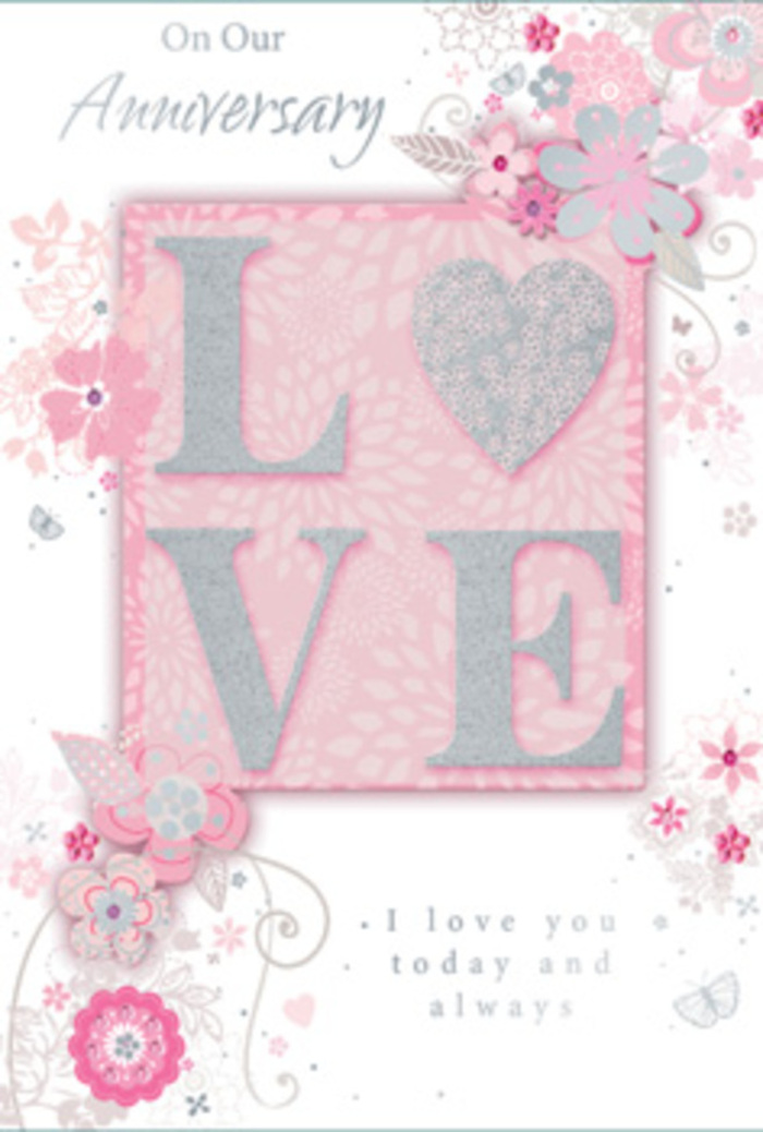 The anniversary card shown in the image feels like a paper interpretation of a romantic bouquet, created with the same care a local Palmers Green florist brings to tying satin ribbon around fresh stems. At its heart is the word LOVE, rendered in large, raised capitals that stand out from the surface in creamy blush pink. Each letter is dusted with a fine layer of glitter, glinting softly like morning frost on petals in a Palmers Green garden. The tactile relief suggests a pleasant sensation under the fingertips, giving the card an almost sculpted quality. Behind and around this central motif, a wash of pale pink forms a tender backdrop, reminiscent of softly tinted wrapping tissue around a bouquet. Delicate, stylised flowers and feathery leaves encircle the word, drawn in graceful lines of pearly white with subtle touches of silver. Their carefully shaded petals curl and overlap, suggesting the layered forms of roses and other romantic blooms so often chosen for anniversary arrangements. Thin tendrils of foliage curl into gentle loops, mimicking the natural movement of stems woven by hand. Small glimmers of silver foil appear here and there, adding an understated sparkle similar to candlelight reflecting off glass vases in homes along Green Lanes and nearby residential streets. Elegant, flowing script carries heartfelt anniversary sentiments, the calligraphy echoing the curves of the vines. The overall impression is one of calm, enduring devotion: a soft, dreamlike design that would pair beautifully with an anniversary bouquet delivered across Palmers Green to celebrate love that has quietly deepened over the years.
